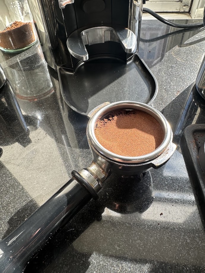 Ground coffee being distributed in an espresso portafilter